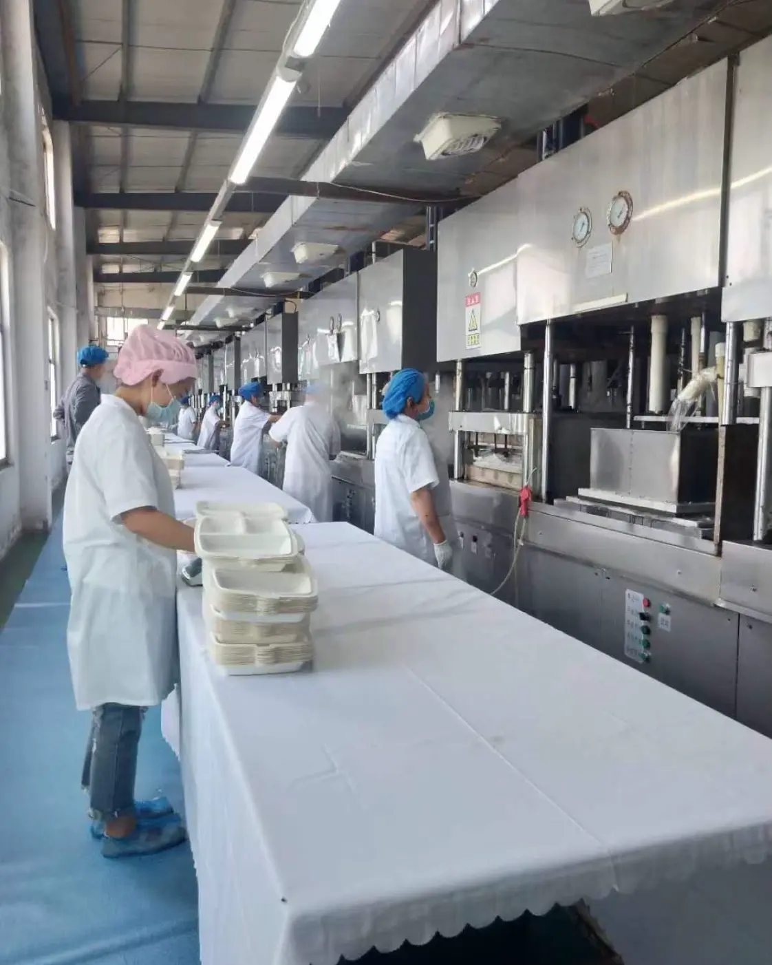 Bagasse tableware manufacturing equipment operated by workers in Youshang factory